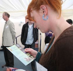 A delegate takes in some information at the conference. A delegate takes in some information at the conference.