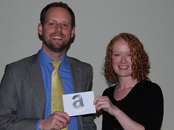 James Armstrong receives his prize from Communications Manager Jaclyn Green 