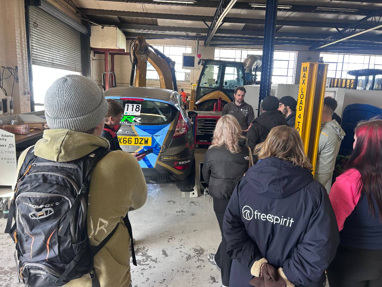 A group of young people working with the Harper Adams rally car