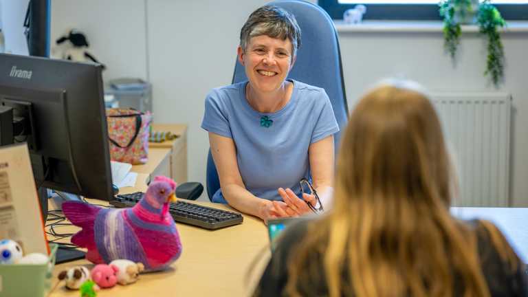 A student services staff member chats to a young woman