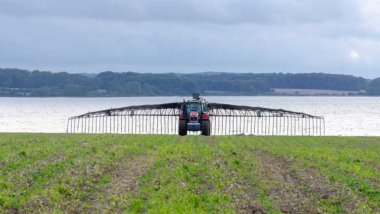 A machine spreads slurry on a field