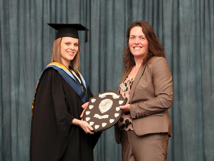 Christina receives the award from Nicky Naylor