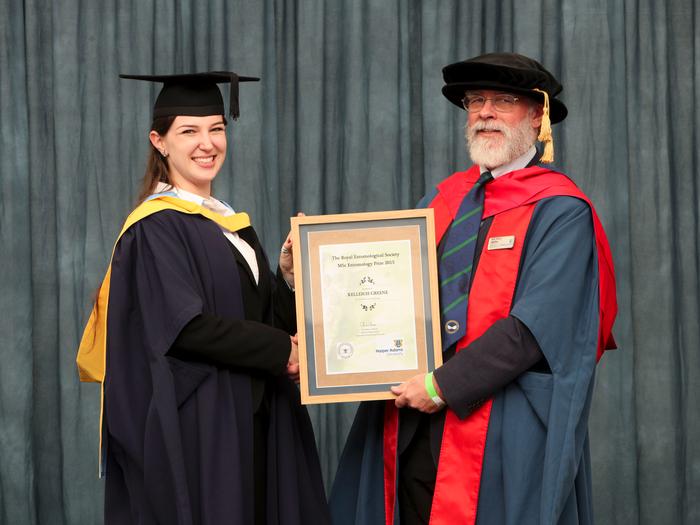 Kelleigh receives the award from Professor Simon Leather