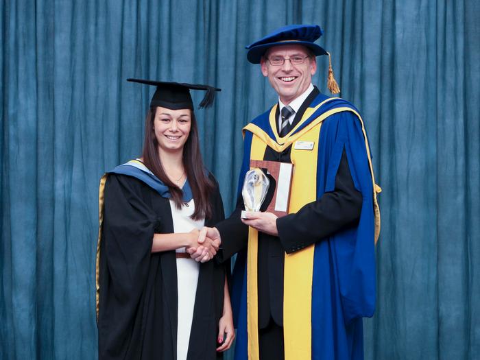 Laura receives her award from Dr Martin Hare