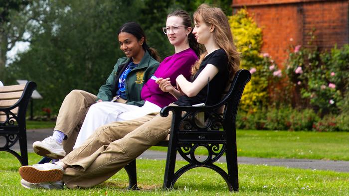 Young  researchers  sitting on a bench at Harper Adams University