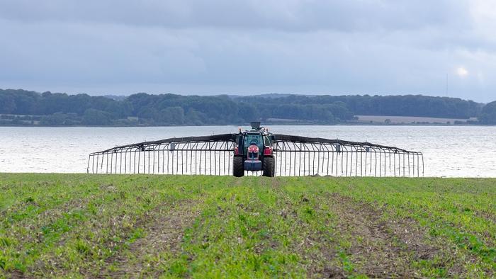 A machine spreads slurry on a field