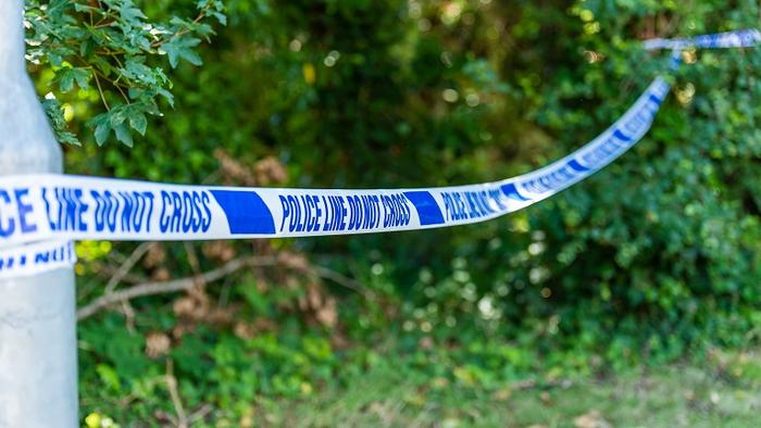 Police tape in a rural location